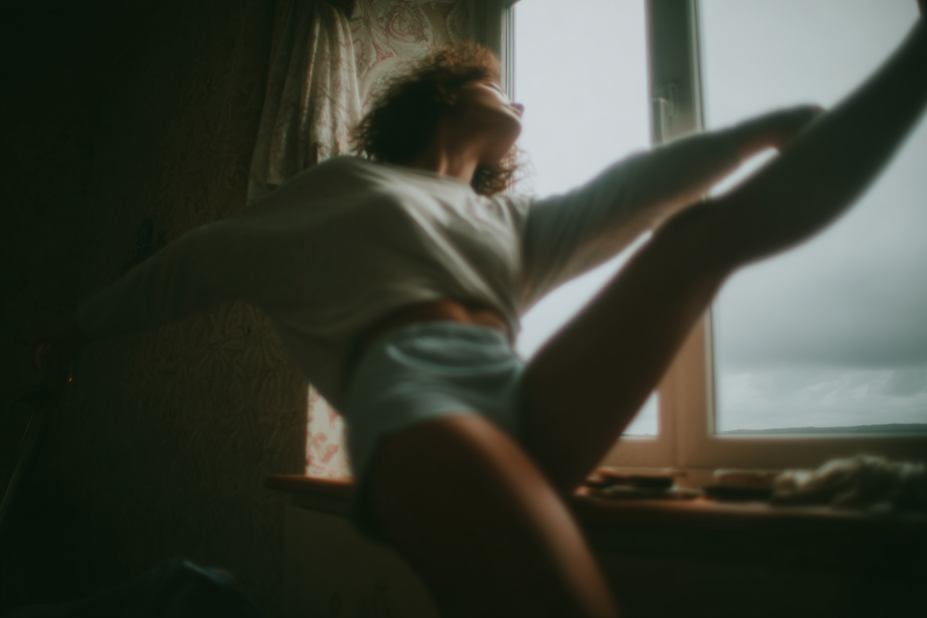 Quiet morning, light stretching by a window